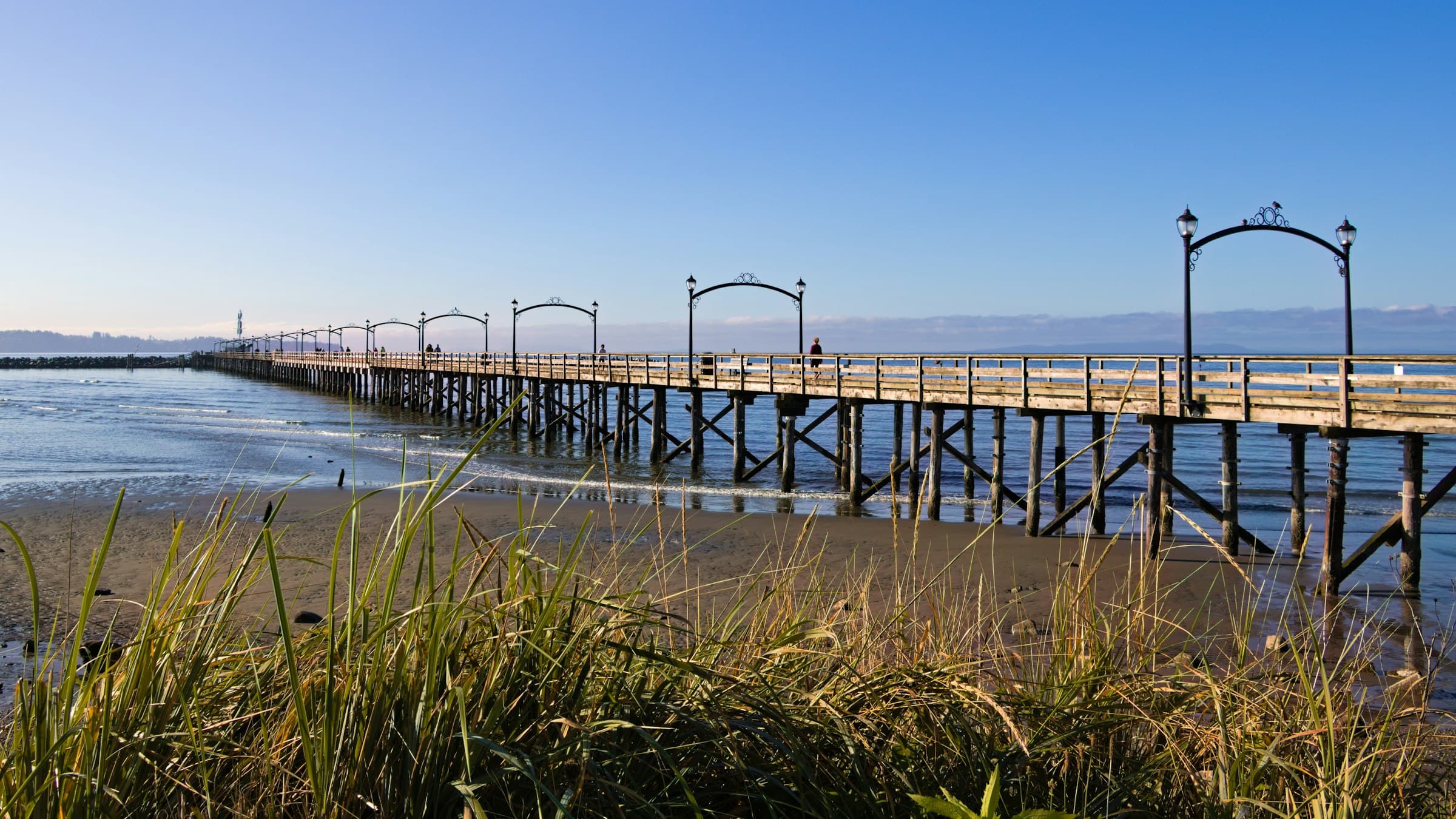 The White Rock pier stretching over the water in South Surrey, BC